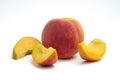 One peach with several sliced Ã¢â¬â¹Ã¢â¬â¹peach isolated on white background Royalty Free Stock Photo